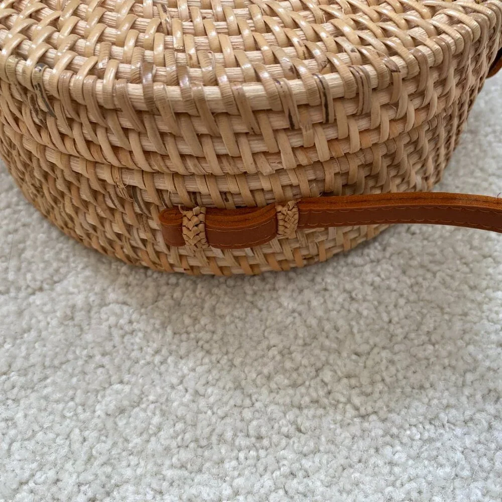 Round solid rattan woven crossbody purse cloth lined, leather accents.